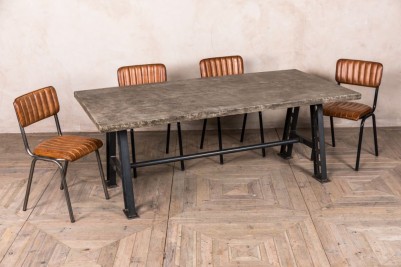 concrete-look-table-with-a-frame-base-and-arlington-chairs